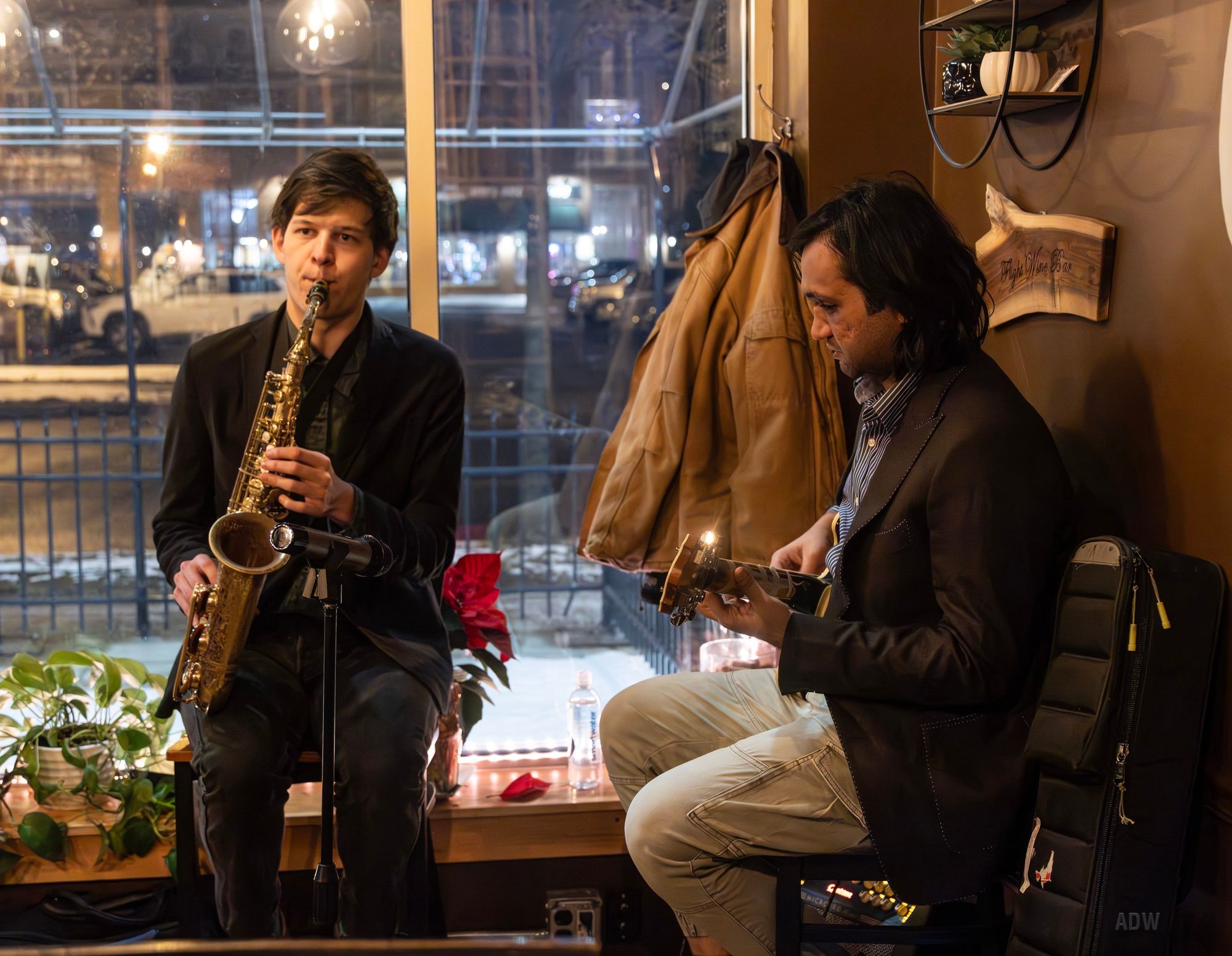 Eshaan sood and a saxophone player performing in a cafe